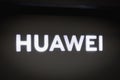 Close-up on the HUAWEI logo on a decorative wall in store