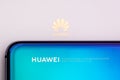 Closeup of a Huawei smartphone on its white box with Huawei logo