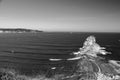 Close up of huge cliff rock of deux jumeaux in atlantic ocean with waves in black and white Royalty Free Stock Photo