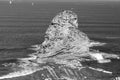 Close up of huge cliff rock one of deux jumeaux in atlantic ocean with waves in black and white Royalty Free Stock Photo