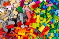 Close-up of huge pile of stackable plastic toy bricks top view. Colorful texture childhood education and development concept