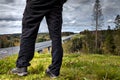 Close-up of human feet on background of forest roadway. Royalty Free Stock Photo