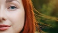 Close-up human female half face pretty teenager beautiful redhead girl woman sensuality model with beautiful blue eyes Royalty Free Stock Photo