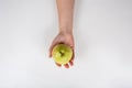 Close up of a human hand holding a fresh pear isolated on white background with copy space. Bio delicious fruits. Healthy organic Royalty Free Stock Photo