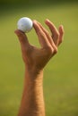 Close-up of human hand holding golf ball