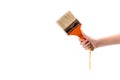 Human hand holding a paint brush isolated on white background Royalty Free Stock Photo