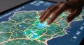 Close up of a human hand interacting with a detailed digital map displaying complex interconnected routes and data points Royalty Free Stock Photo