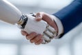 Close-up of a human hand shaking a robotic hand symbolizing artificial intelligence collaboration and future technology Royalty Free Stock Photo