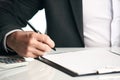 Close up of human hand signing a document Royalty Free Stock Photo