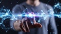 Close up of a human hand touching a glowing blue digital network of interconnected lines and nodes Royalty Free Stock Photo