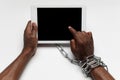 Close up of human hand using tablet with blank black screen. Tied with chain, addiction Royalty Free Stock Photo