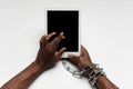 Close up of human hand using tablet with blank black screen. Tied with chain, addiction Royalty Free Stock Photo