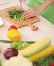 Close-up of human hands cooking vegetables salad in kitchen. Healthy meal and vegetarian concept Royalty Free Stock Photo