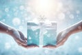 Close up of human hands holding blue gift box with christmas tree Royalty Free Stock Photo