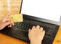 Close-up human hands holding a credit card and using computer. o Royalty Free Stock Photo