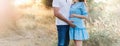 Close up of human hands holding pregnant belly, closeup happy family awaiting baby, standing on green grass, body part, young fami Royalty Free Stock Photo