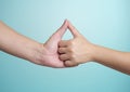 Close up of human hands touching with thumb