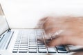 Close-up of Human Hands typing on laptop in blurred motion with Royalty Free Stock Photo