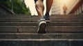 close-up of human legs running up wide stairs in sneakers and shorts