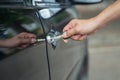 Close up of human male hand opening car door. Royalty Free Stock Photo
