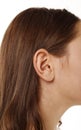 Close up human woman`s ear over white background Royalty Free Stock Photo