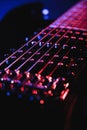 Close-up of a humbucker. Detail of six-string electric guitar, soft selective focus. With colorful blue and purple illumina Royalty Free Stock Photo