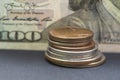 Close-up of a hundred-dollar bill and a stack of dimes, selective focus. Concept :banking operations, cash settlement, currency ex