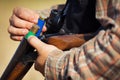 Close-up of a hunter loading his shotgun