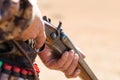 Close up of hunter loading shotgun, holds a gun and ammunition