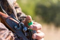 Close up of hunter loading shotgun, .holds a gun and ammunition