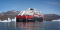 Close up of Hurtigruten`s MS Fridtjof Nansen expedition cruise ship amidst icebergs with zodiacs off loading in Disko Bay, Greenla