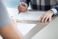 Close up of husband signing divorce decree in office