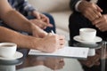 Close up of husband signing contract with wife near