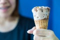 Close up of ice cream cone hold in hand by happy girl