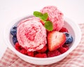 Close Up ice cream mixed berry fruits raspberry ,blueberry ,strawberry and peppermint leaves setup in white bowl on white wooden Royalty Free Stock Photo