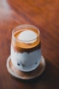 Close up ice dirty coffee style coffee cup with on wood table at Royalty Free Stock Photo