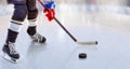 Close up of ice hockey player with stick on ice rink controlling puck Royalty Free Stock Photo