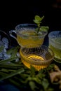 Close up of Iced lemon grass tea in a transparent cup on wooden surface with raw lemon grass green tea in a cup and sugar in a cla Royalty Free Stock Photo