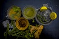 Close up of Iced lemon grass tea in a transparent cup on wooden surface with raw lemon grass green tea in a cup and sugar in a cla Royalty Free Stock Photo