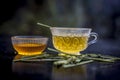 Close up of Iced lemon grass tea in a transparent cup on wooden surface with raw lemon grass green tea in a cup and sugar in a cla Royalty Free Stock Photo