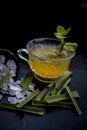 Close up of Iced lemon grass tea in a transparent cup on wooden surface with raw lemon grass green tea in a cup and sugar in a cla Royalty Free Stock Photo