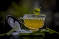 Close up of Iced lemon grass tea in a transparent cup on wooden surface with raw lemon grass green tea in a cup and sugar in a cla Royalty Free Stock Photo