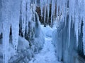 CLOSE UP: Icicles hang above an empty walkway weaving through winter wonderland
