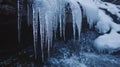 Close-up of Icicles Hanging Over a Frozen Stream Royalty Free Stock Photo