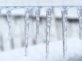 Close-up on icicles under a wood rail-Stock photos