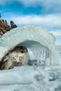 Close-up of the icy seashore. Transparent ice and icicles on the rocks on the shore . Royalty Free Stock Photo