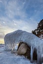 Close-up of the icy seashore. Transparent ice and icicles on the rocks on the shore . Royalty Free Stock Photo