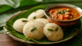 Close-up idli - rice cakes, and sambar - lentil-based curry, a popular South Indian breakfast or snack combination
