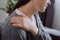 Close up of ill sad young caucasian woman massaging rubbing stiff sore shoulder tensed muscles fatigued, feeling hurt joint back Royalty Free Stock Photo