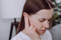 Close up of ill upset young caucasian woman have ear pain or earache, female suffering painful otitis from loud or noisy sound, Royalty Free Stock Photo